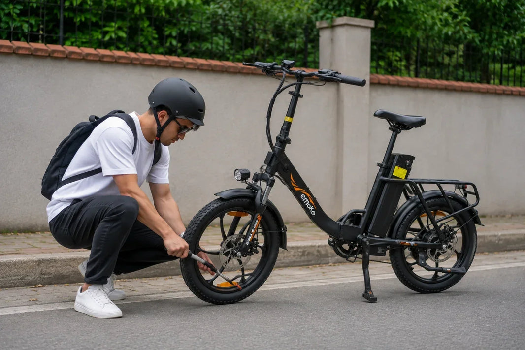 Cyclist inflating an EMOKO electric bike tire during a roadside emergency without a standard floor pump