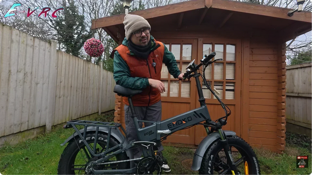 Commuter easily folding the Emoko EC20 full suspension electric bike outdoors, demonstrating portability for urban travel.